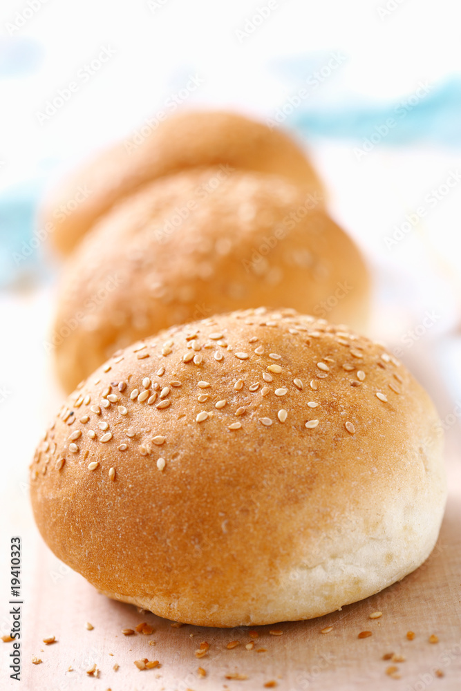 Three wheat buns with sesame