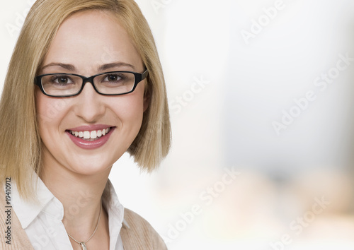 portrait of young businesswoman, smiling, close up