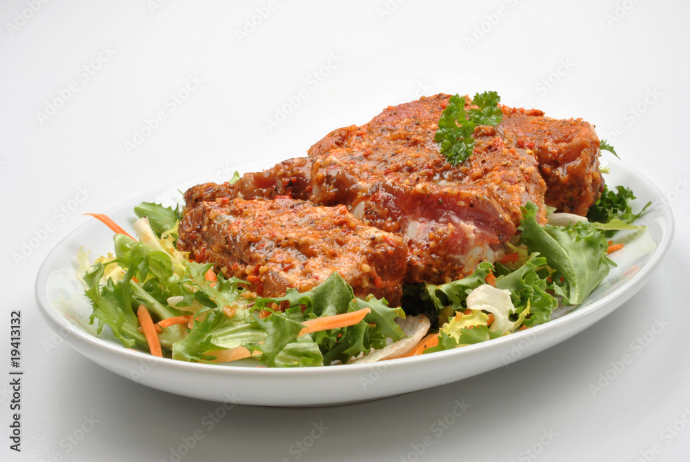 some marinated organic rib on healthy salad