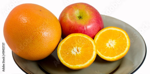 Grapefruit  apple and half of orange on a plate
