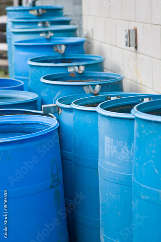 Blue rain barrels in a row flowing into each other