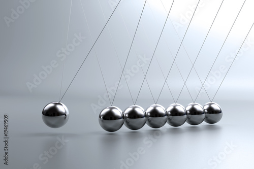Metal pendulum balls balancing from strings in Newton's cradle
