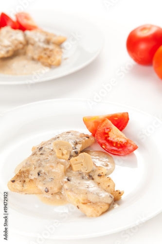 hake fillets with cheese sauce and mushrooms isolated