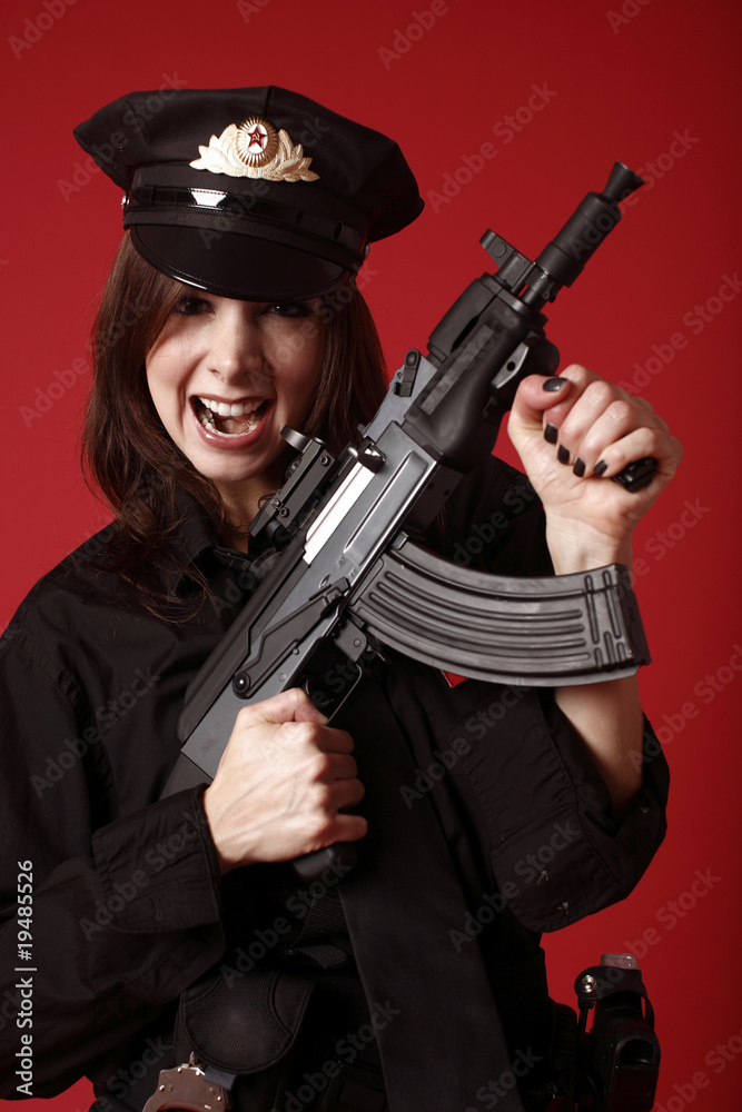 young and sexy officer holding an assault rifle