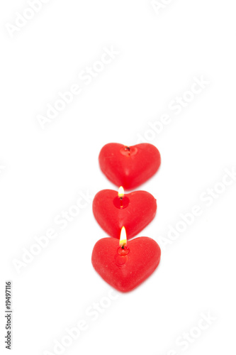 three red candles isolated on white. valentine s day