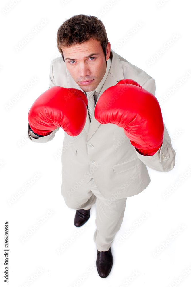 Confident young businessman checking out the competition Confident young businessman checking out the competition
