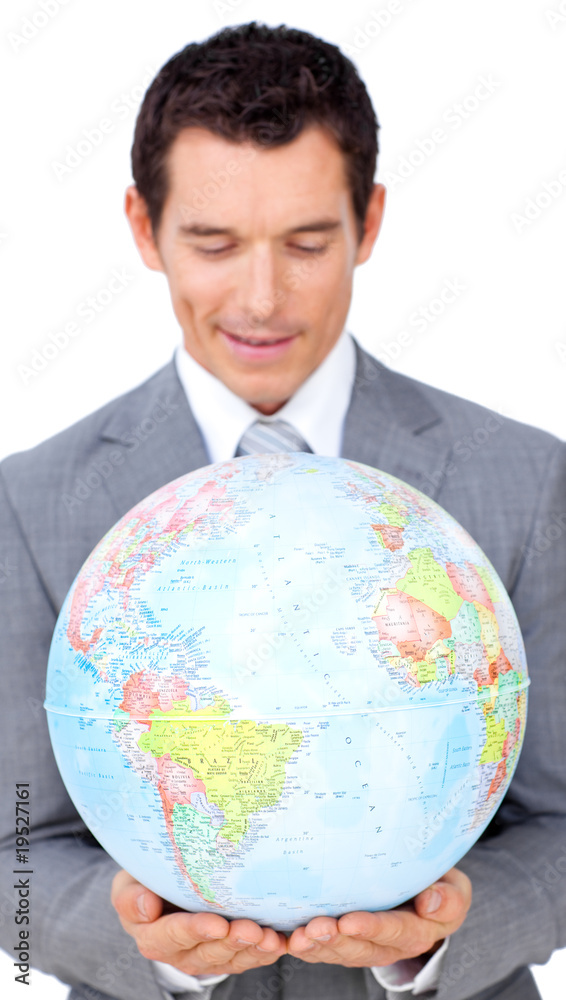 Confident businessman holding a terrestrial globe Confident businessman holding a terrestrial globe