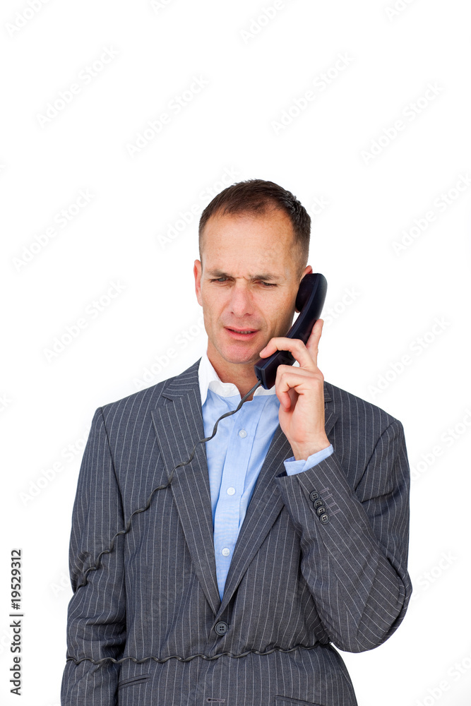 Frustrated businessman tangled up in phone wires Frustrated businessman tangled up in phone wires