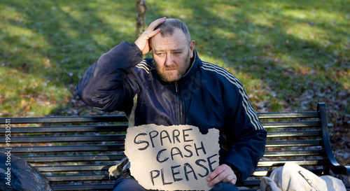 homeless man on park bench begging