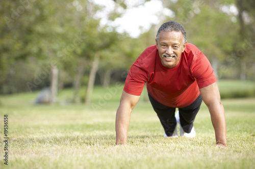 Senior Man Exercising In Park