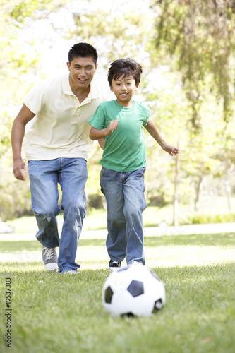 Father And Son In Park With Football © Monkey Business