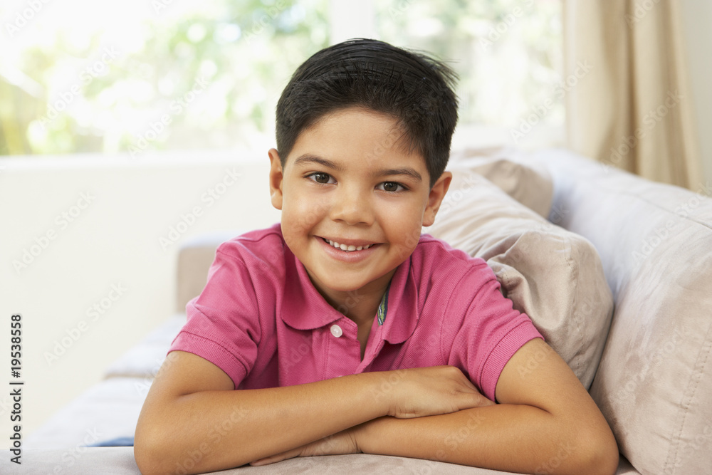 Young Boy Relaxing On Sofa At Home Young Boy Relaxing On Sofa At Home