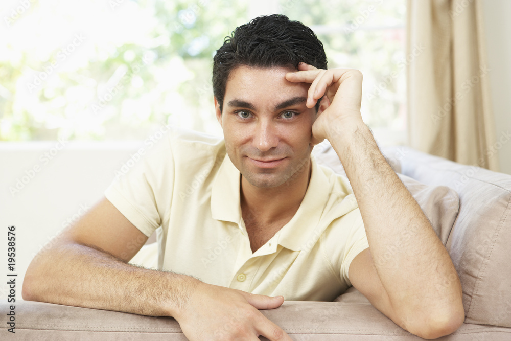 Man Relaxing On Sofa At Home