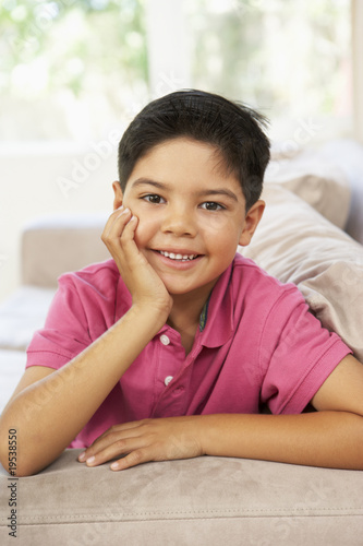 Young Boy Relaxing On Sofa At Home © Monkey Business