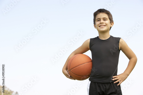 Young Boy Playing Basketball © Monkey Business