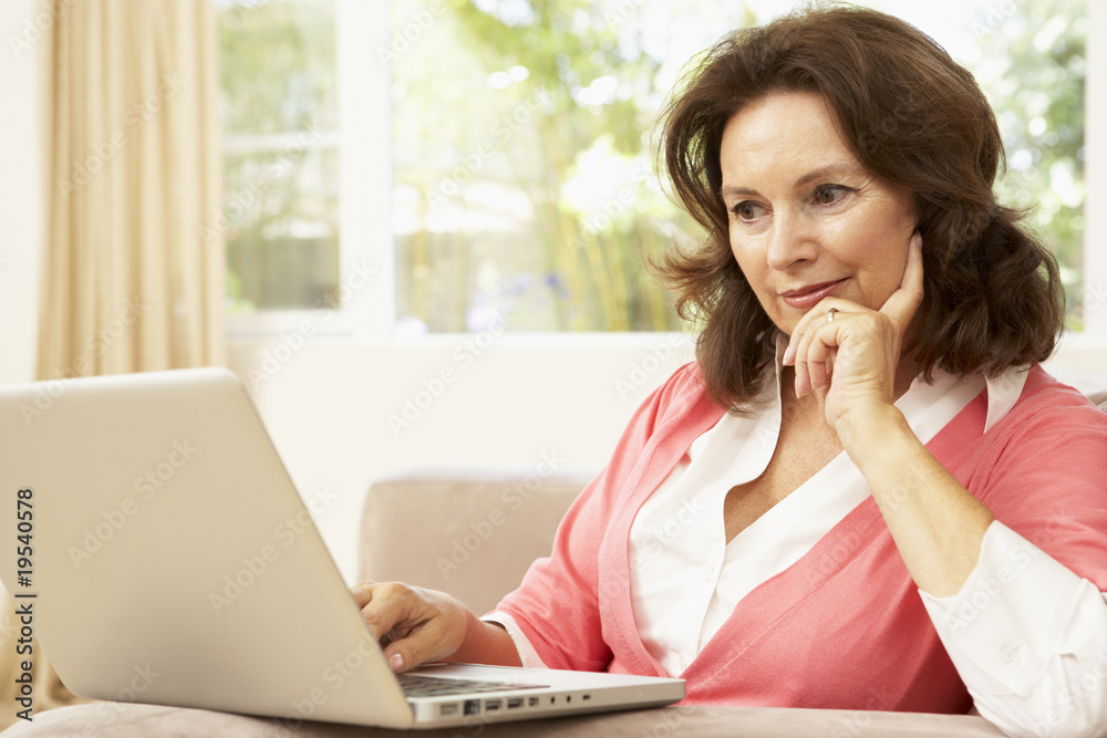 Senior Woman Using Laptop At Home