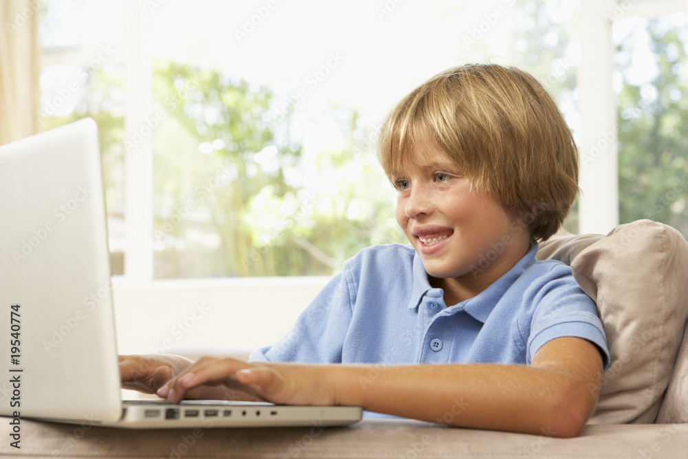 Young boy Using Laptop At Home Young boy Using Laptop At Home