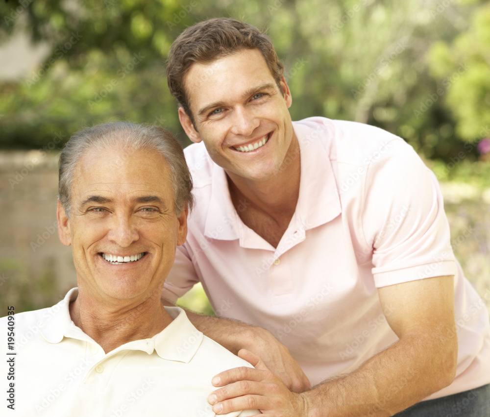 Obraz premium Senior Man Hugging Adult Son