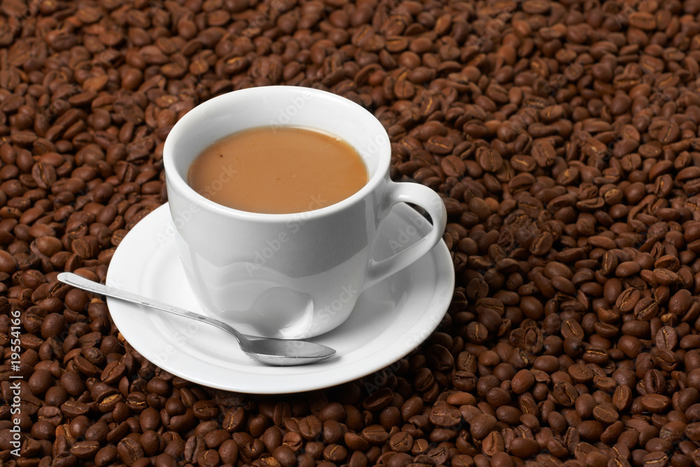 Fototapeta premium Cup with coffee, costing on coffee grain