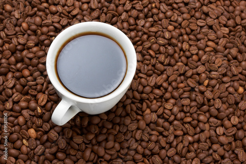 Cup with coffee  costing on coffee grain