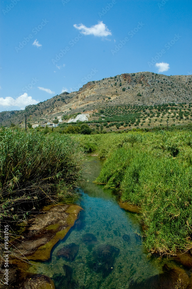 Creek running through mountain fields in Crete, Greece