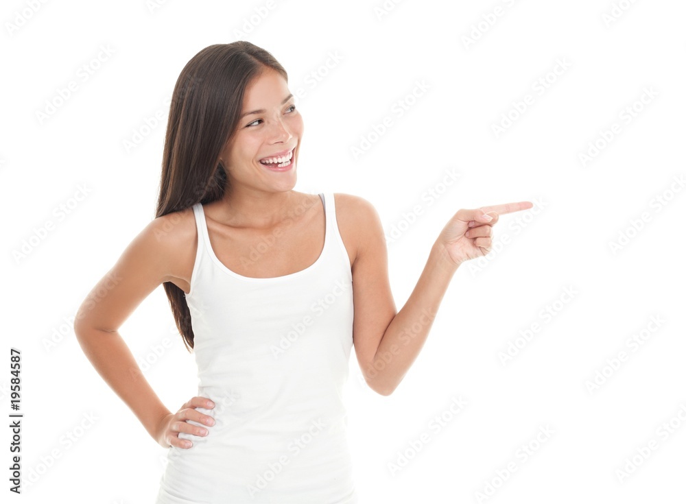 Cute young woman pointing and looking to the side Cute young woman pointing and looking to the side
