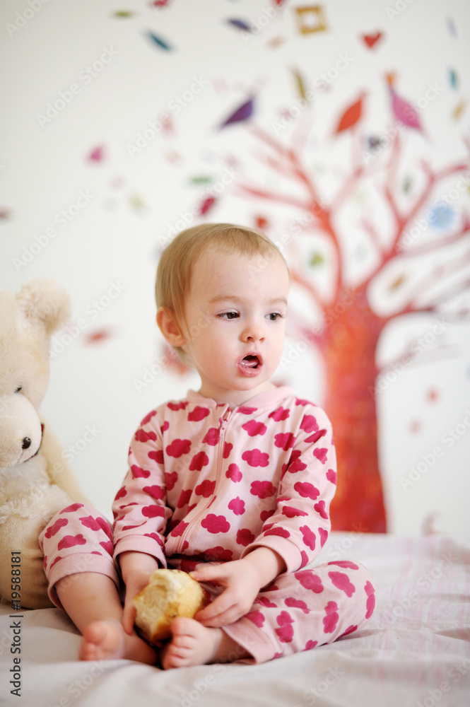 Little baby in bed wearing red pyjamas Little baby in bed wearing red pyjamas