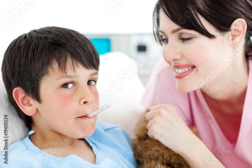 Charming nurse taking little boy s temperature