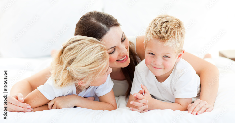 Cute blond boy with his sister and his mother