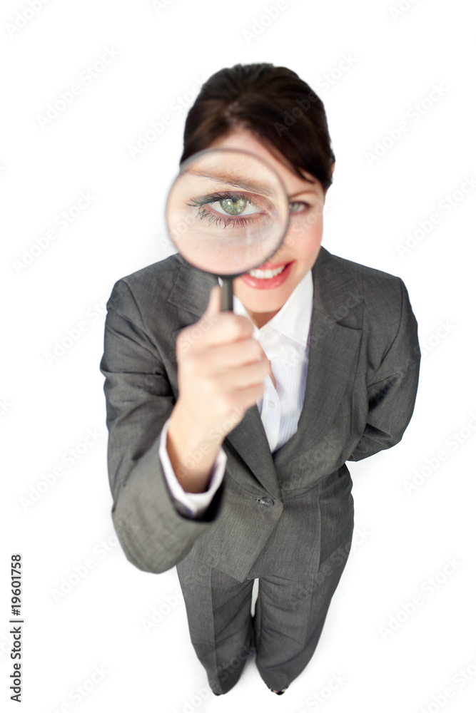 Young businesswoman looking through magnifying glass Young businesswoman looking through magnifying glass