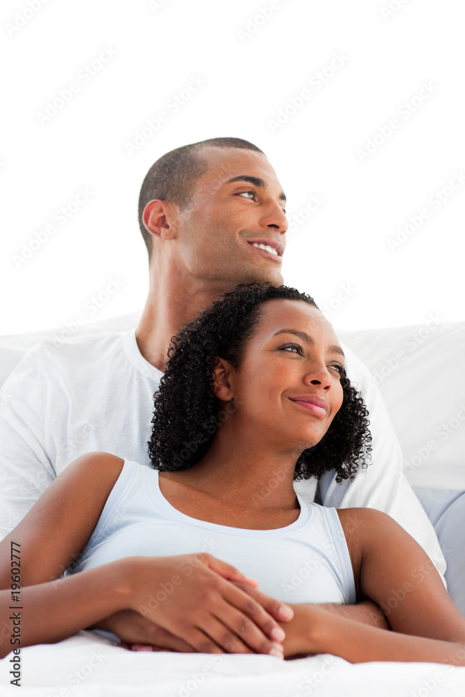 Afro-american lovers hugging on their bed