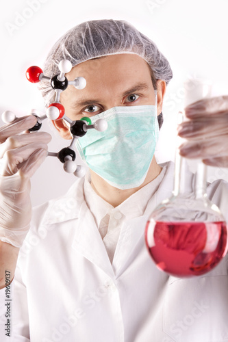 Scientist holding Flask and Atoms photo