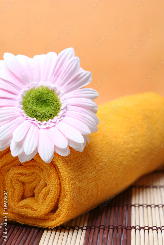 Flowers and yellow towel on a resort Flowers and yellow towel on a resort