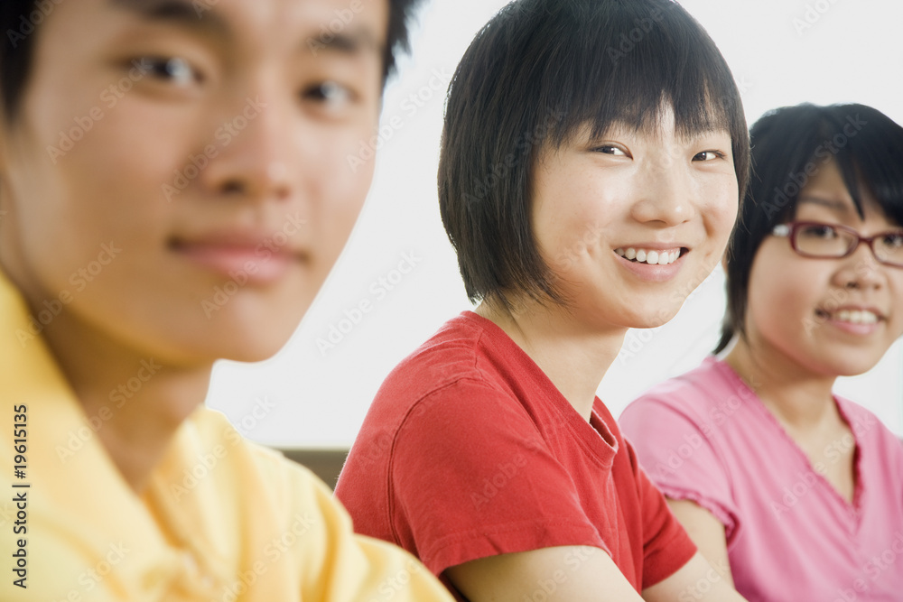 Three Asian People Smiling at Camera Three Asian People Smiling at Camera