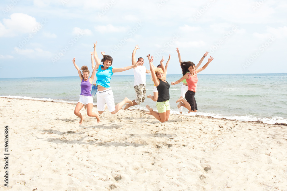 happy people jumping on the beach