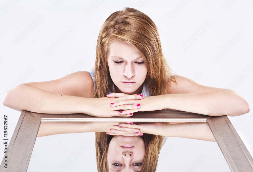 young woman looking into a mirror young woman looking into a mirror