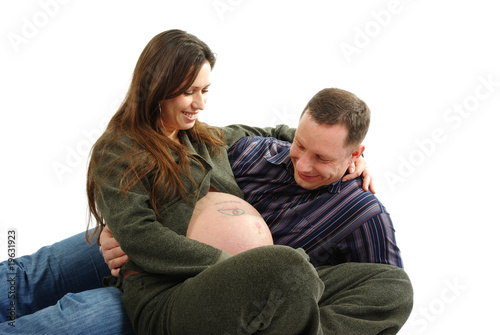 Happy pregnant couple staring at the belly