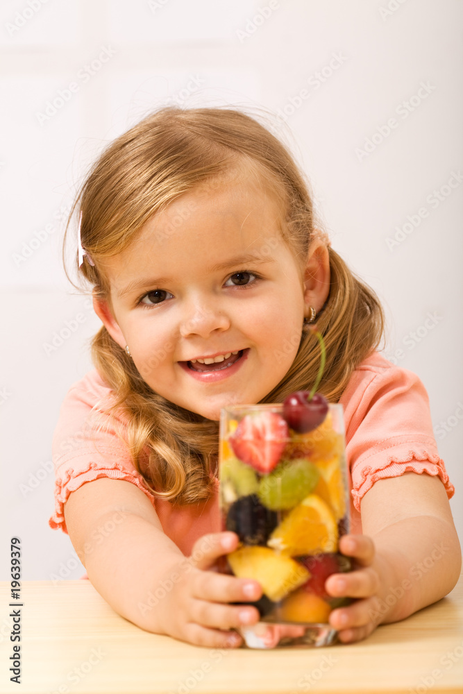 Happy little girl with fruity refreshment Happy little girl with fruity refreshment