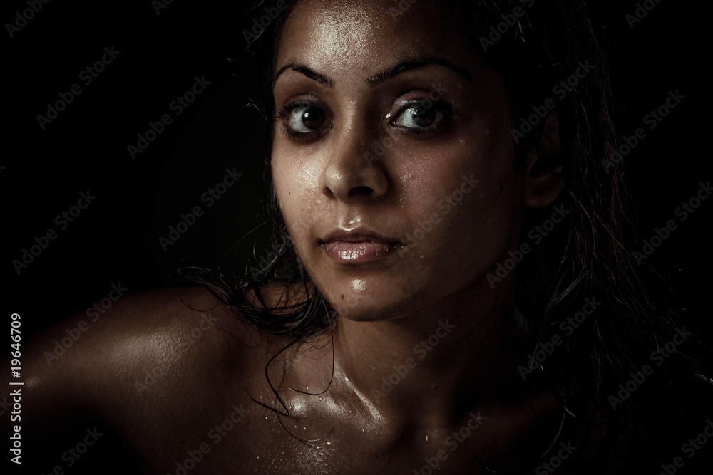 Portrait of beautiful young woman with wet face
