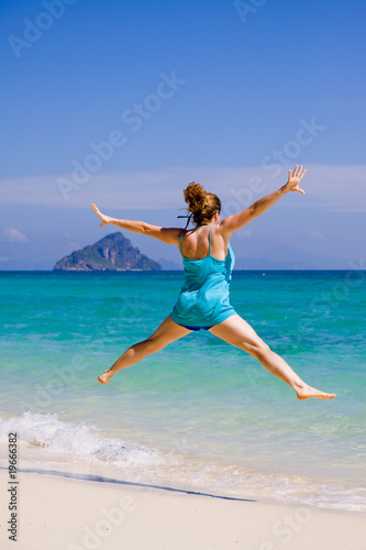 Frau springt am Meer