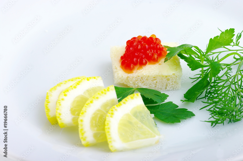 Sandwiches with red caviar and greens on a white plate Sandwiches with red caviar and greens on a white plate