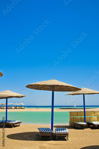 Fototapeta Naklejka Na Ścianę i Meble -  Straw umbrellas on the beach of Egypt