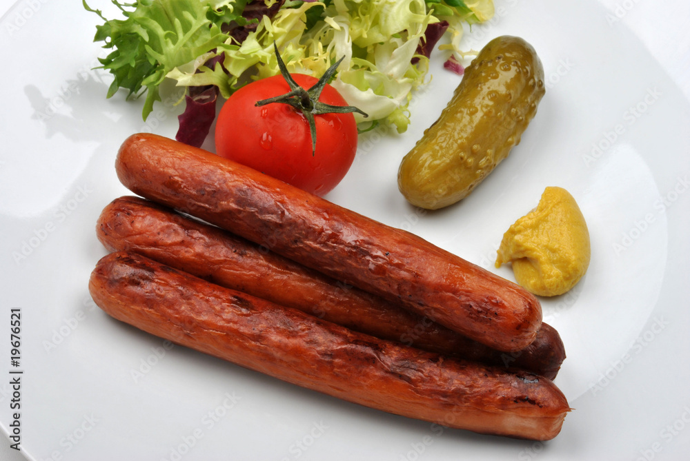 smoked sausage and organic gherkin on a plate smoked sausage and organic gherkin on a plate