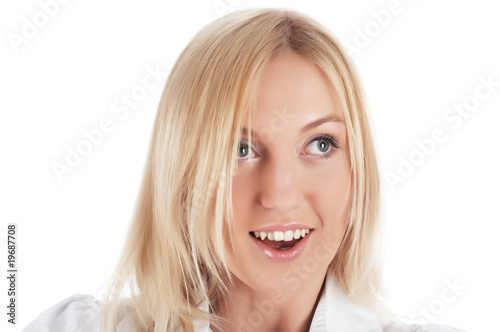 The cheerful charming blonde in a white shirt