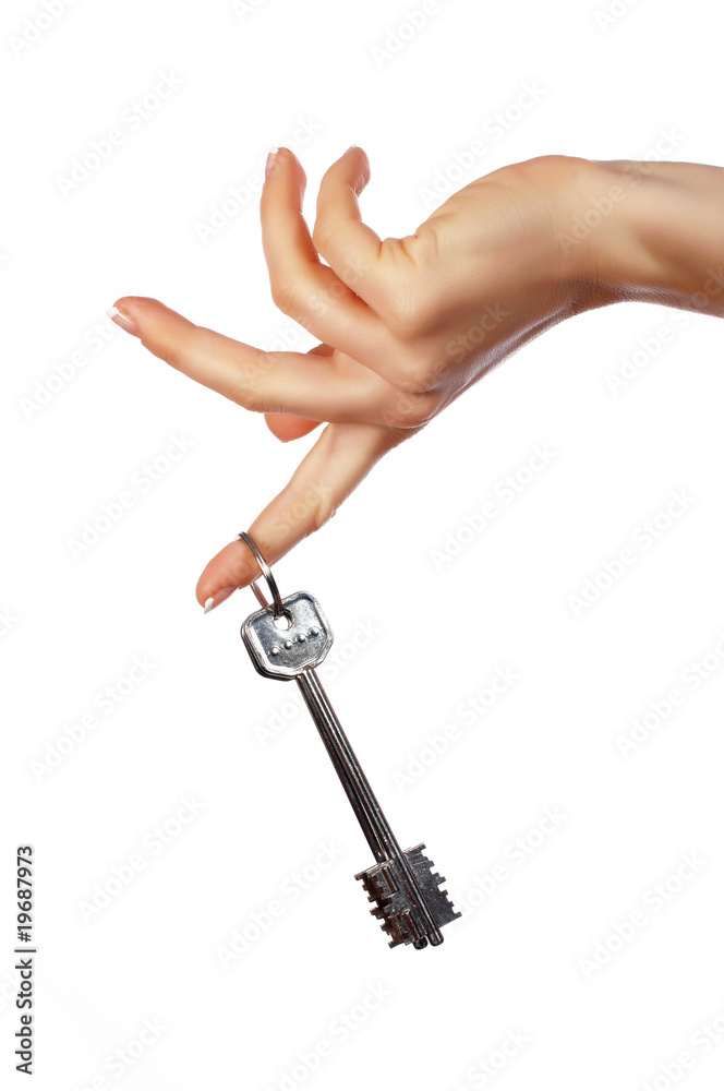 The hand holds a key from the house The hand holds a key from the house