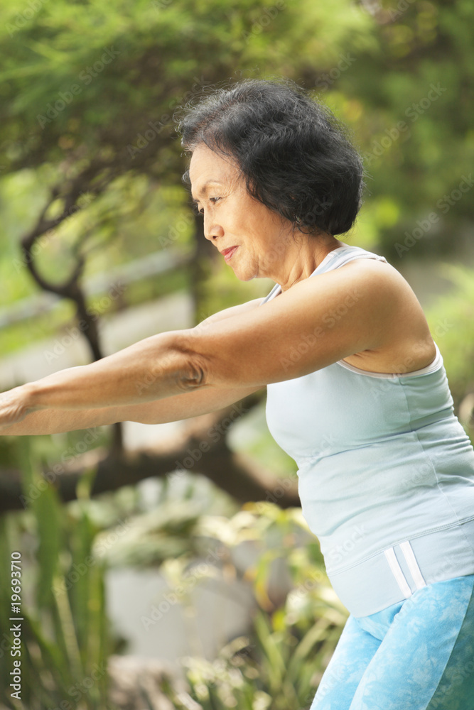 Senior old woman doing yoga in park Senior old woman doing yoga in park