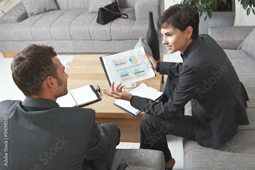Businesspeople discussing charts