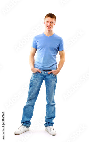 Young man standing with hands in pockets..