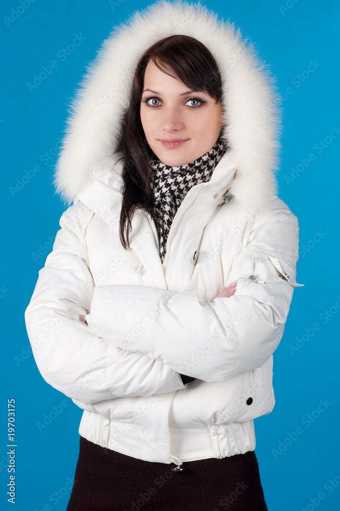 beautiful happy woman in winter clothes. On blue background . beautiful happy woman in winter clothes. On blue background .
