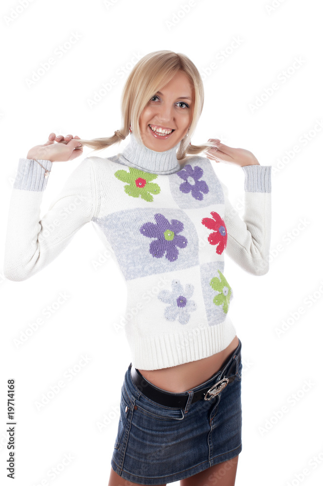 The charming smiling blonde in a sweater with flowers The charming smiling blonde in a sweater with flowers